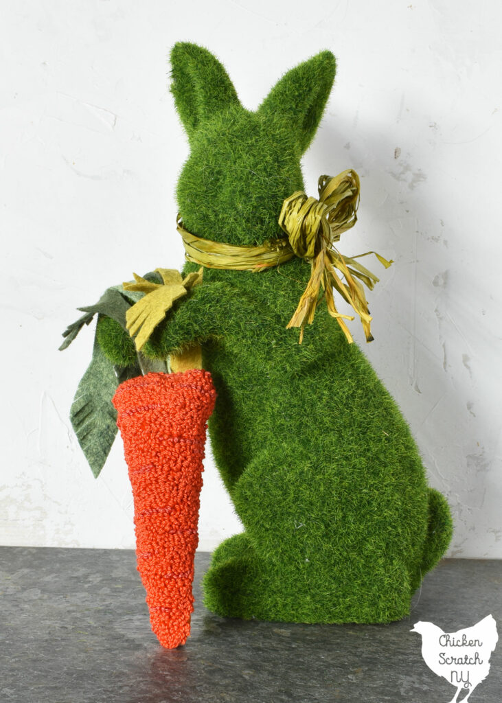 green moss bunny holding an orange punch needle carrot