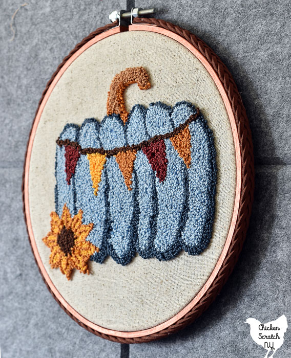 blue pumpkin embroidery decorated with metallic copper paint and braided leather trim