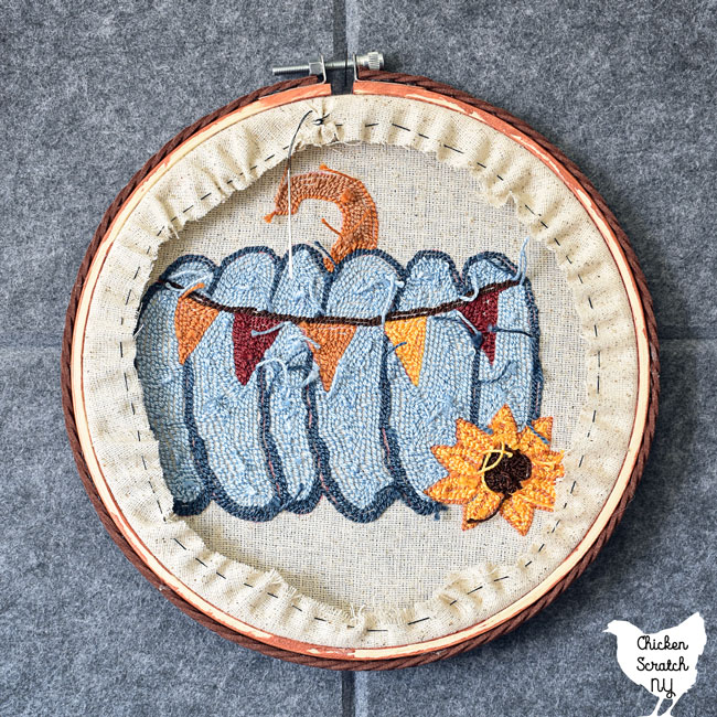back of embroidery hoop showing the stitching used to keep the fabric from showing on the front